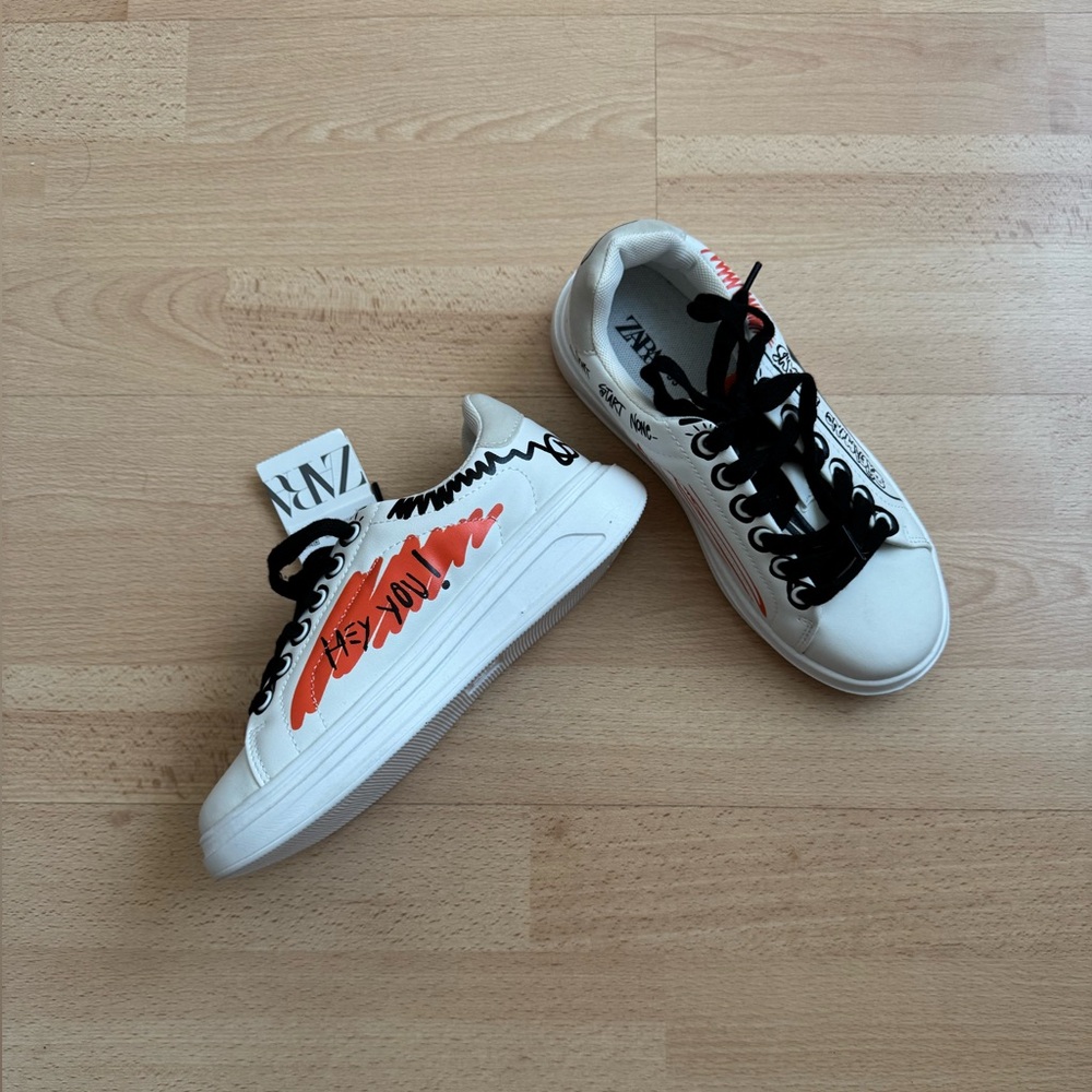 White Sneakers with Orange and Black Accents